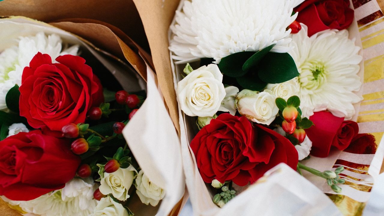 Beautiful holiday bouquet with red roses, greenery, and seasonal winter flowers at an Asheville holiday event.