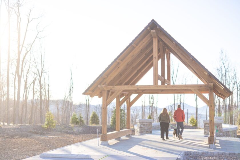 Two people walking along Tea House Ridge in winter at The Ramble.