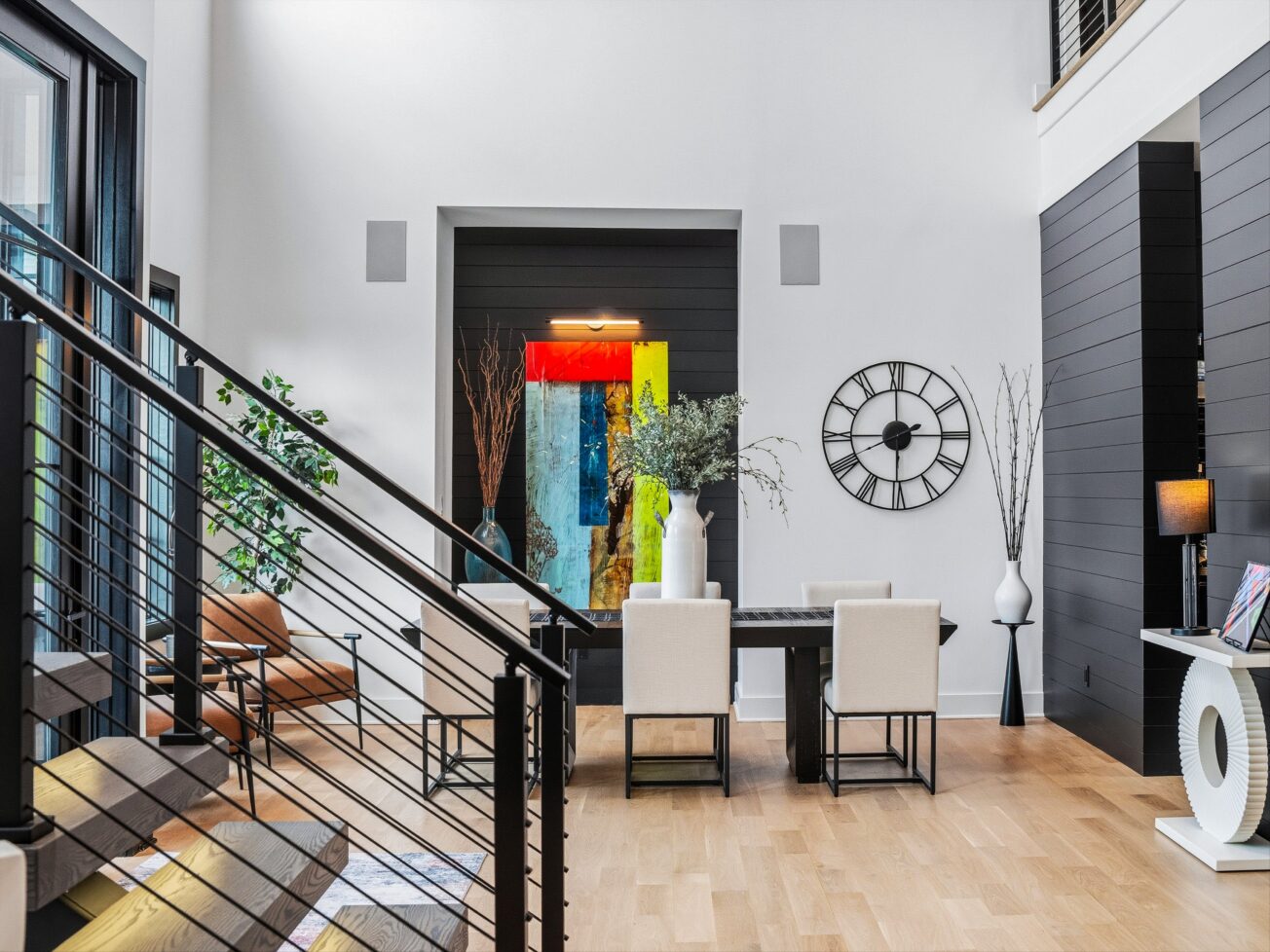 Living room with dining room table and colorful artwork.