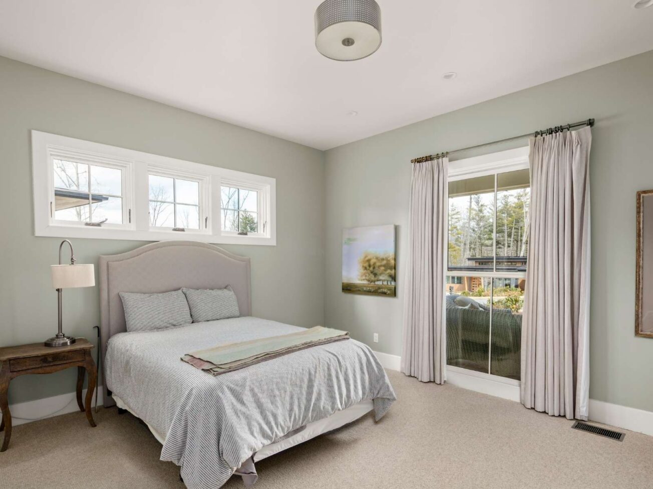 Bedroom with pale green walls.